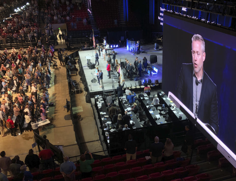 FILE - In this Wednesday, June 13, 2019 file photo, J.D. Greear, president of the Southern Baptist Convention, is shown on a video screen as he addresses the denomination's annual meeting in Birmingham, Ala. As Southern Baptists prepare for their biggest annual meeting in more than a quarter-century in June 2021, accusations that leaders have shielded churches from claims of sexual abuse and simmering tensions around race threaten to once again mire the nation’s largest Protestant denomination in a conflict that can look more political than theological. (AP Photo/Jay Reeves, File)