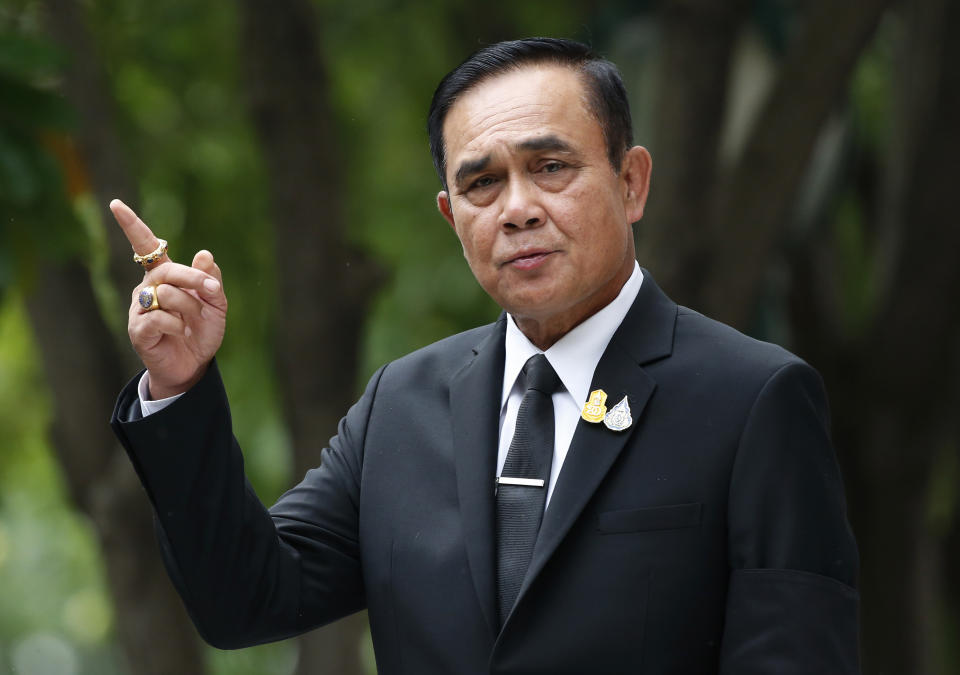 Thailand's Prime Minister Prayuth Chan-ocha talks to reporters before a meeting at government house in Bangkok, Thailand, Thursday, June 6, 2019. Thailand's Parliament elected 2014 coup leader Prayuth Chan-ocha as prime minister in a vote Wednesday that helps ensure the military's sustained dominance of politics since the country became a constitutional monarchy nearly nine decades ago. (AP Photo/Sakchai Lalit)