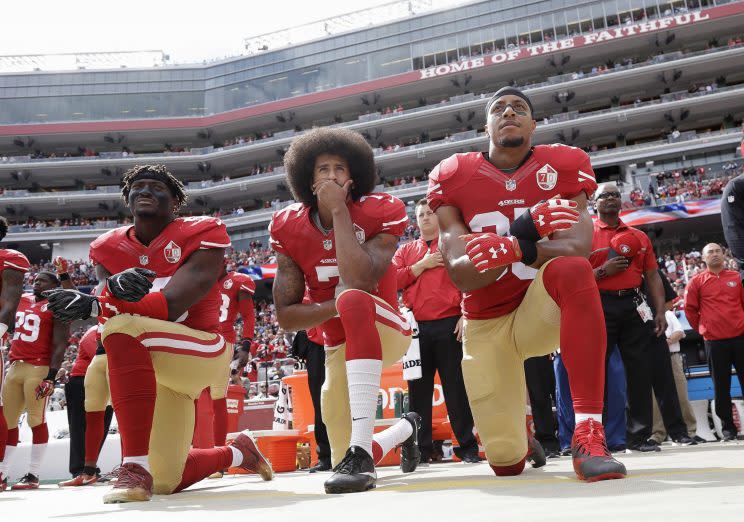 Eli Harold (left), Colin Kaepernick (middle) and Eric Reid (right) have said they won't kneel for the national anthem this year. (AP)