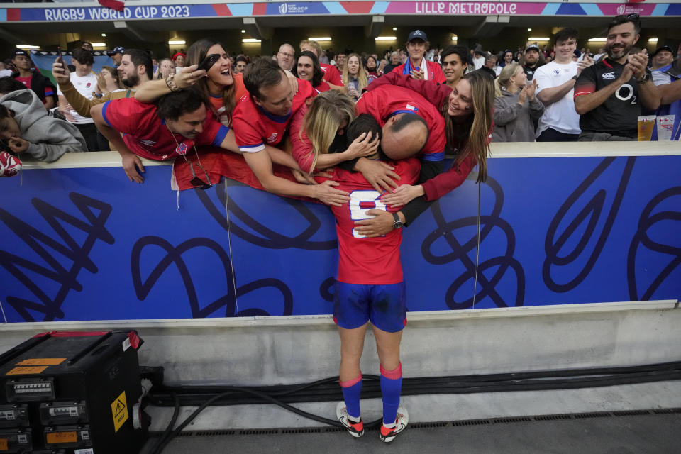 Chile's Benjamin Videla is hugged by supporters at the end of the Rugby World Cup Pool D match between England and Chile at the Stade Pierre Mauroy in Villeneuve-d'Ascq, outside Lille, Saturday, Sept. 23, 2023. (AP Photo/Themba Hadebe)