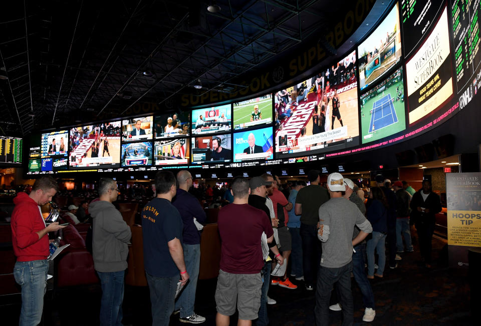 LAS VEGAS, NV - MARCH 15:  Guests line up to place bets as they attend a viewing party for the NCAA Men's College Basketball Tournament inside the 25,000-square-foot Race & Sports SuperBook at the Westgate Las Vegas Resort & Casino which features 4,488-square-feet of HD video screens on March 15, 2018 in Las Vegas, Nevada.  (Photo by Ethan Miller/Getty Images)