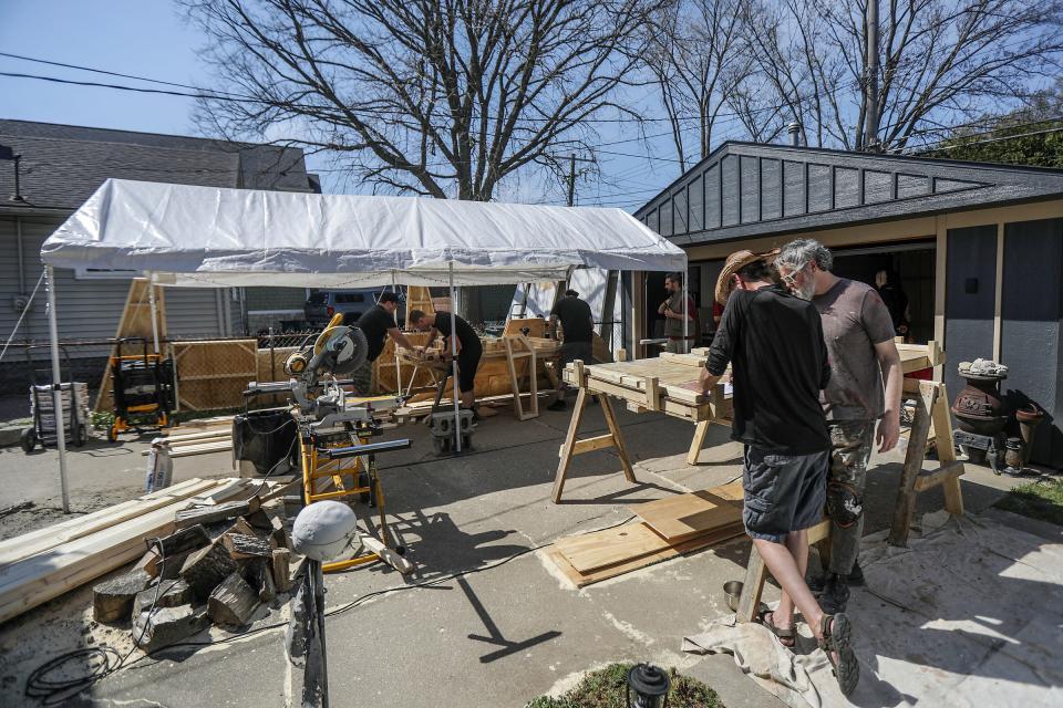 The build crew from Space Dive 313 works in Brett Carson’s backyard constructing custom interiors for the upcoming party, while he and co-creator John Dunivant look over blueprints for the build on Sunday, April 14, 2024.