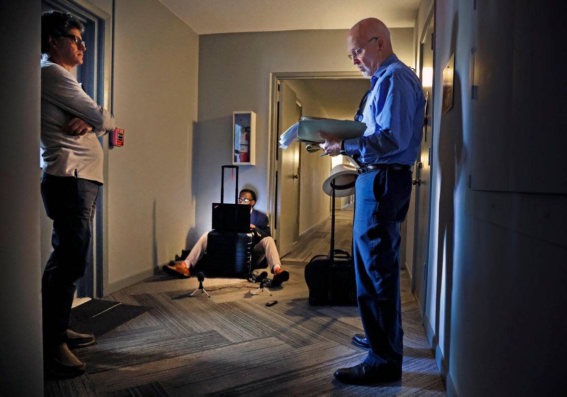 Attorney Brad Schandler, at right, takes bids during the auction of condominium unit 119A at Oakland Grove Village Condominium in Oakland Park, Florida on Tuesday, February 27, 2024. Court reporter Gary Siffort of Esquire Deposition Solutions, seated on the floor, takes notes as Mauricio J. Riquer, owner of Max Rigz Enterprises, a residential contractor company, offers bids.