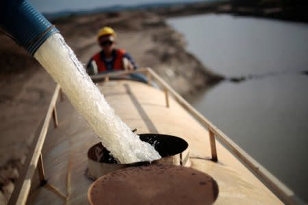 FILE PHOTO: A worker fills a truck with water pumped from one of the canals being built to divert water from the Sao Francisco river for use in four drought-plagued states, near the city of  Mauriti, Ceara state, January 28, 2014. REUTERS/Ueslei Marcelino/File Photo