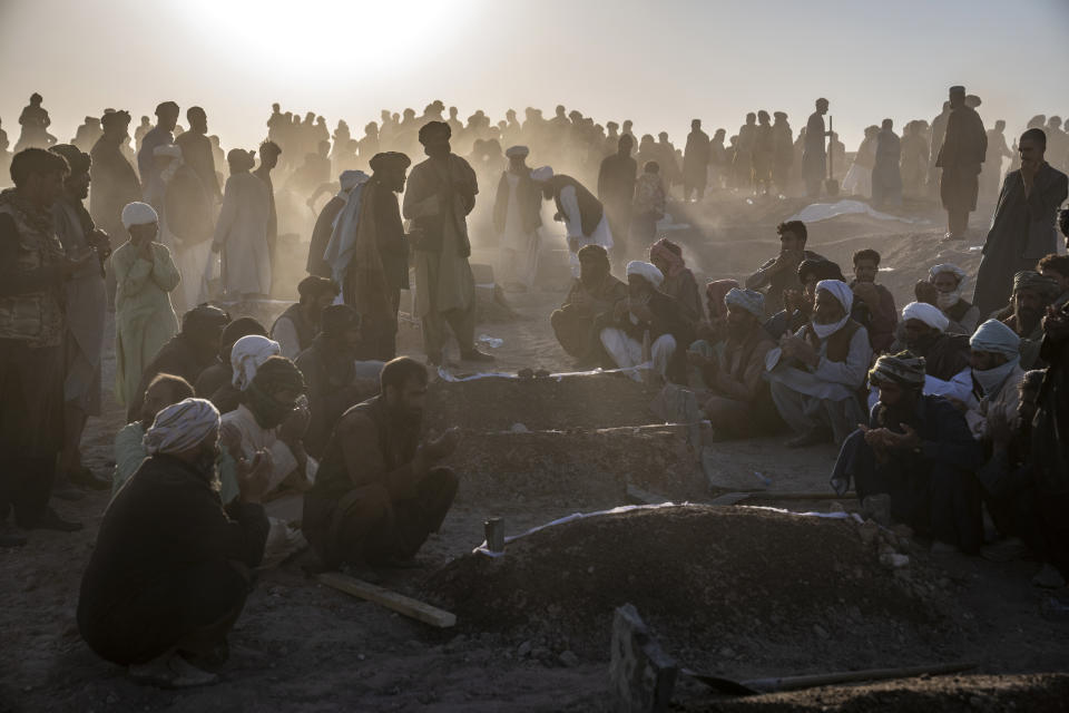 Afghans bury hundreds of people killed in an earthquake to a burial site, in a village in Zenda Jan district in Herat province, western of Afghanistan, Monday, Oct. 9, 2023. Saturday's deadly earthquake killed and injured thousands when it leveled an untold number of homes in Herat province. (AP Photo/Ebrahim Noroozi)