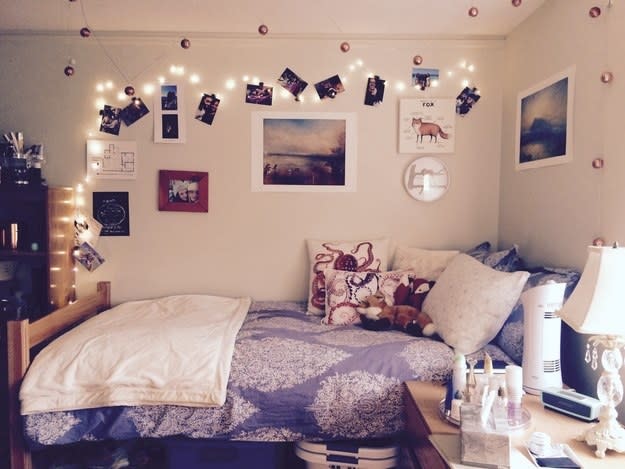 A dorm room with fairly lights and octopus-logo pillows