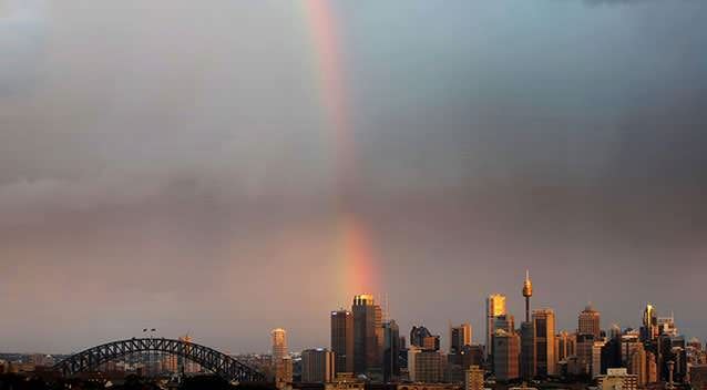 A rainbow appears over the Sydney Harbour Bridge at sunset. Photo: Getty