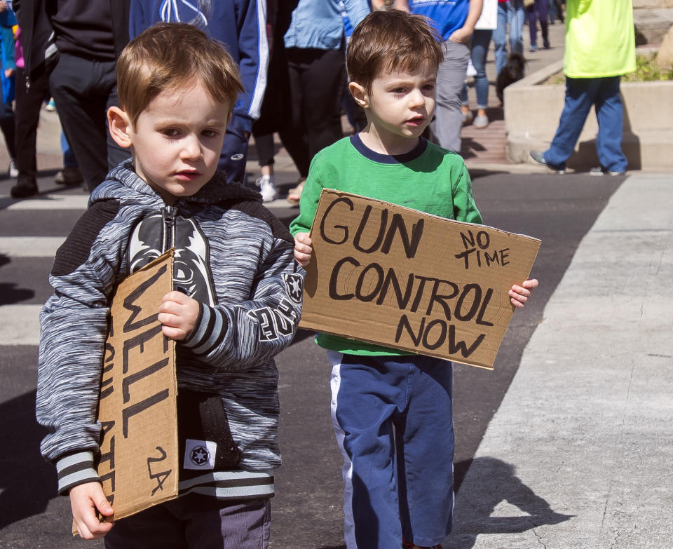 <p>Four-year-old twins Eli, left, and his brother Nathan Hellman hold their signs during the ‘March For Our Lives’ event in Colorado Springs, Colo. (Dougal Brownlie/The Gazette via AP) </p>