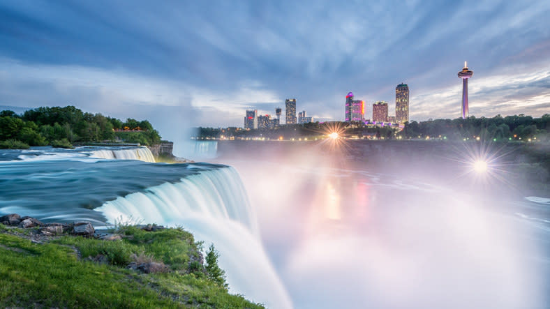 The waterfall with the cityscape in the background