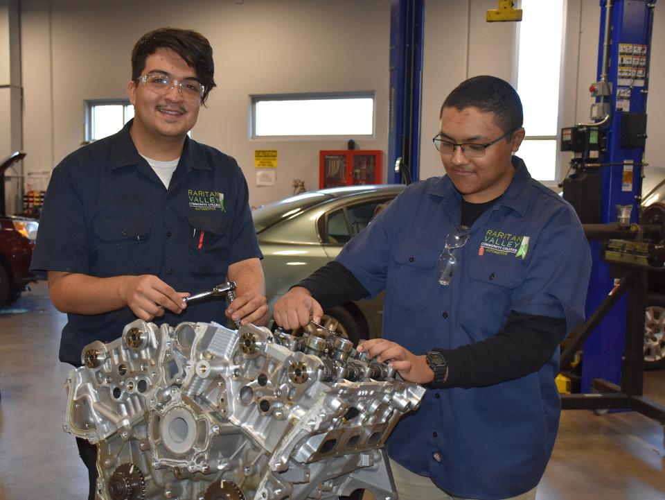 Raritan Valley Community College students Alex Guerrero, left, and Nick Cruz work on one of the 17 gasoline test engines donated to RVCC’s  Automotive Technology program by ExxonMobil’s Technology Center in Clinton.