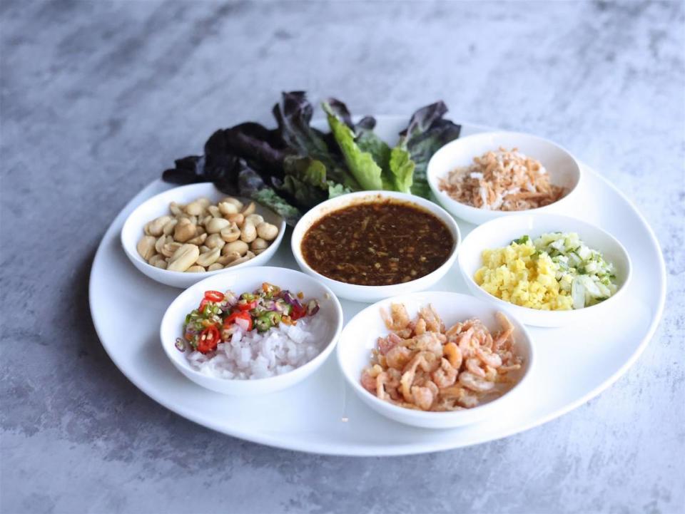 One appetizer, the miang khum, comes with betal leaf wraps that customers top with dried shrimp, toasted coconut, peanut, ginger, shallot, lime, Thai chili, fermented shrimp paste and palm sugar. ​