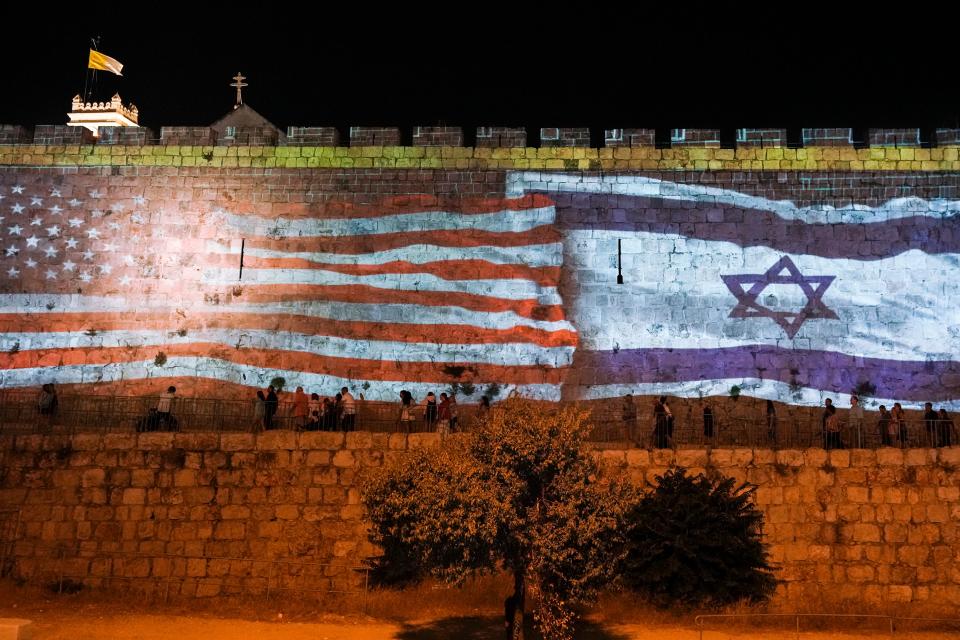 Israeli authorities project an image of the Israeli and U.S. flags on the walls of Jerusalem's Old City in honor of July Fourth. President Joe Biden is set to visit Israel and the West Bank as part of a broader trip to the Middle East.