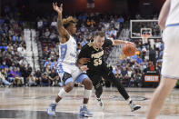 Purdue's Sasha Stefanovic (55) drives to the basket as North Carolina's Anthony Harris (0) defends in the second half of an NCAA college basketball game, Saturday, Nov. 20, 2021, in Uncasville, Conn. (AP Photo/Jessica Hill)