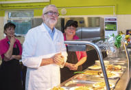 Labour leader Jeremy Corbyn joins canteen staff to help serve school dinners to staff and students at Bilton High School in Rugby, while on the General Election campaign trail in England, Thursday, Dec. 5, 2019. (Joe Giddens/PA via AP)
