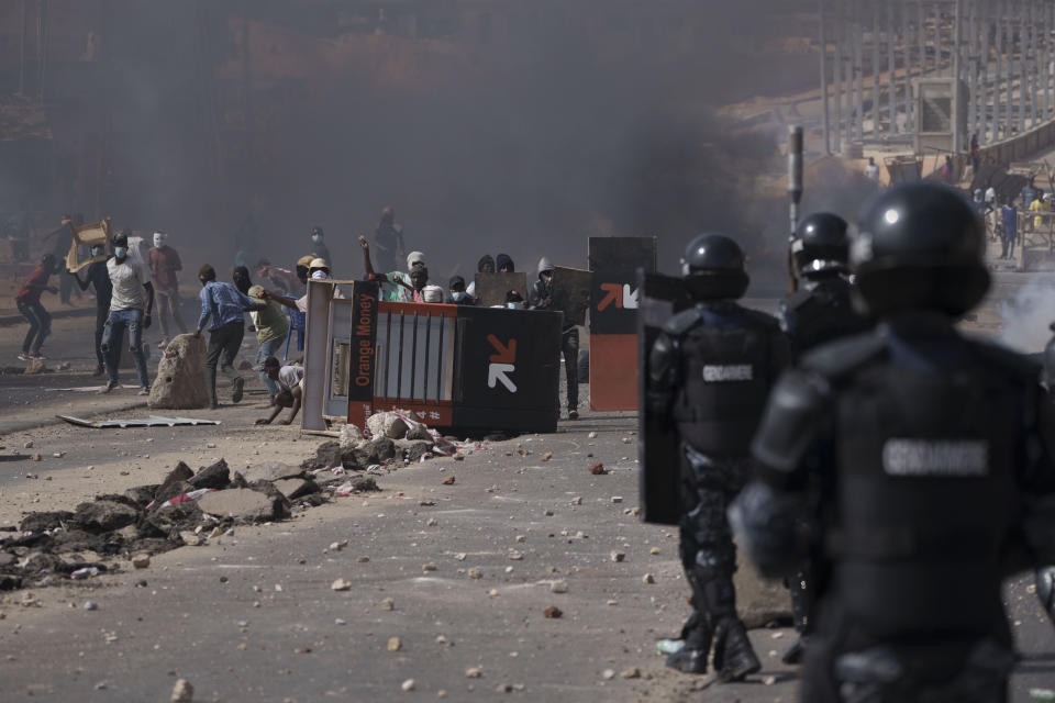 Demonstrators clash with riot policemen at a neighborhood in Dakar, Senegal, Friday, June 2, 2023. Clashes between police and supporters of Senegalese opposition leader Ousmane Sonko left nine people dead, the government said Friday, with authorities issuing a blanket ban on the use of several social media platforms in the aftermath of the violence (AP Photo/Leo Correa)