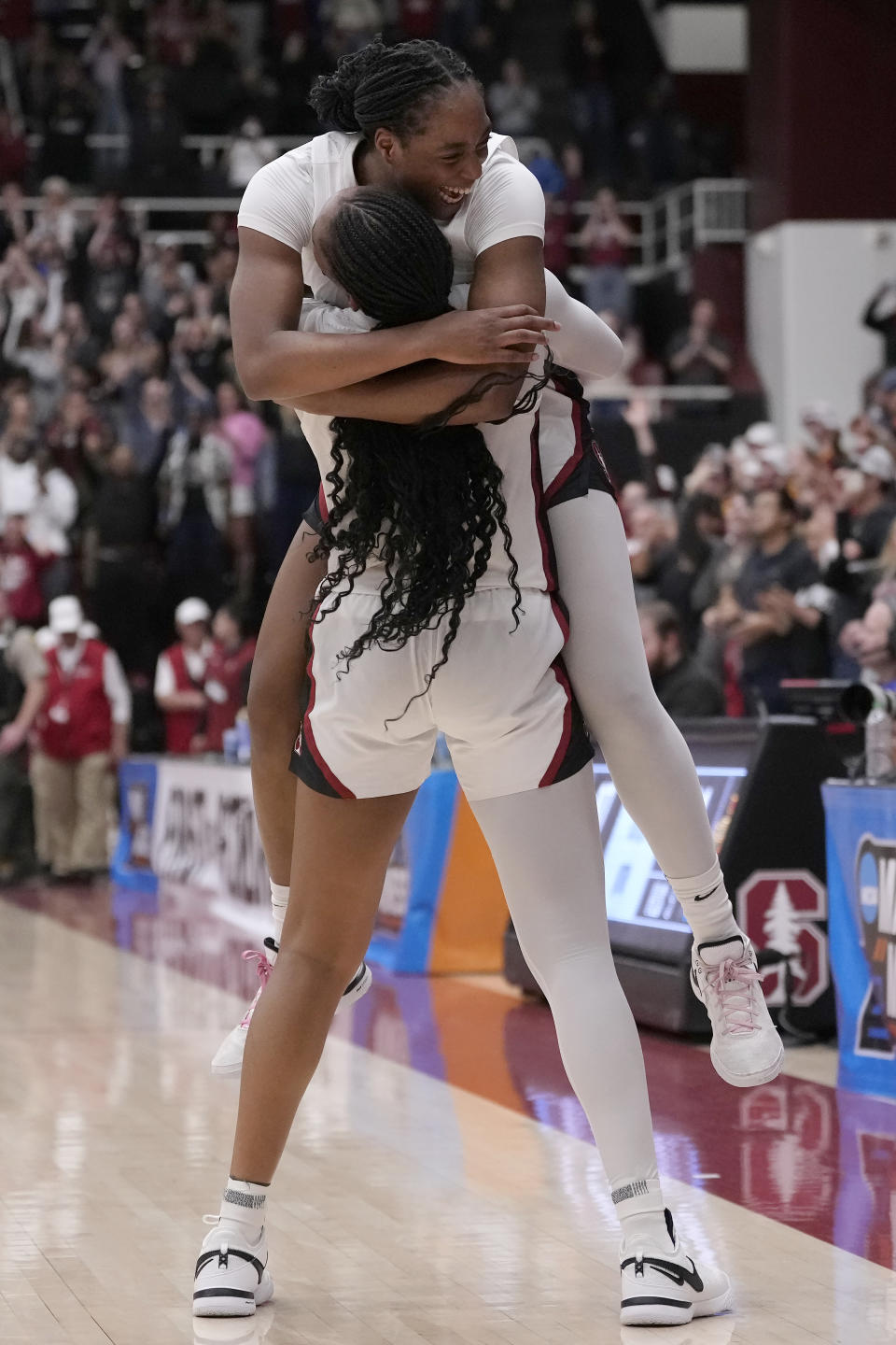 Stanford forward Nunu Agara, top, and forward Kiki Iriafen celebrate after Stanford defeated Iowa State in overtime of a second-round college basketball game in the women's NCAA Tournament in Stanford, Calif., Sunday, March 24, 2024. (AP Photo/Jeff Chiu)