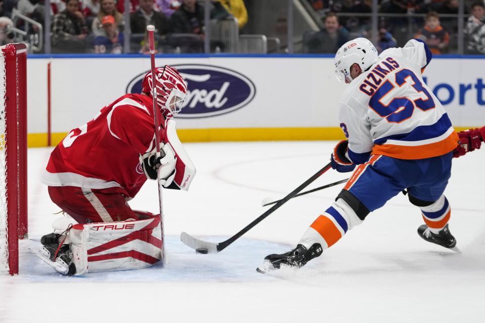 New York Islanders' Casey Cizikas, right, shoots the puck past Detroit Red Wings goaltender Ville Husso for a goal during the second period of an NHL hockey game, Monday, Oct. 30, 2023, in Elmont, N.Y. (AP Photo/Frank Franklin II)
