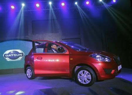 Kenichiro Yomura, President of Nissan Motor India, drives a "Datsun GO" car onto the stage during its launch in New Delhi March 19, 2014. REUTERS/Anindito Mukherjee