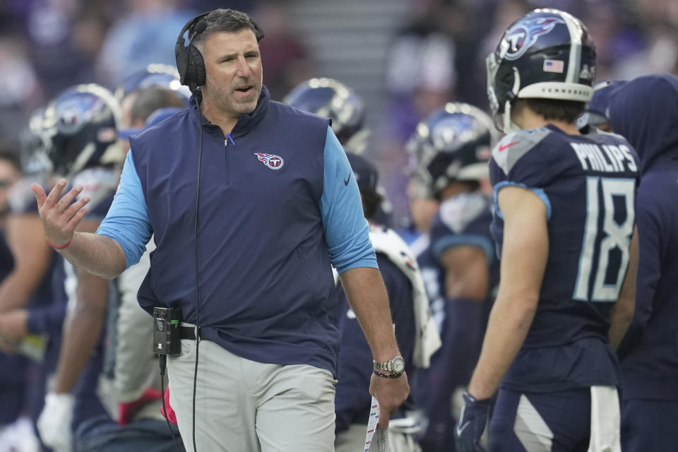 Tennessee Titans head coach Mike Vrabel talks to wide receiver Kyle Philips (18) on the sideline during the second half of an NFL football game against the Baltimore Ravens, Sunday, Oct. 15, 2023, at the Tottenham Hotspur stadium in London. (AP Photo/Kin Cheung)