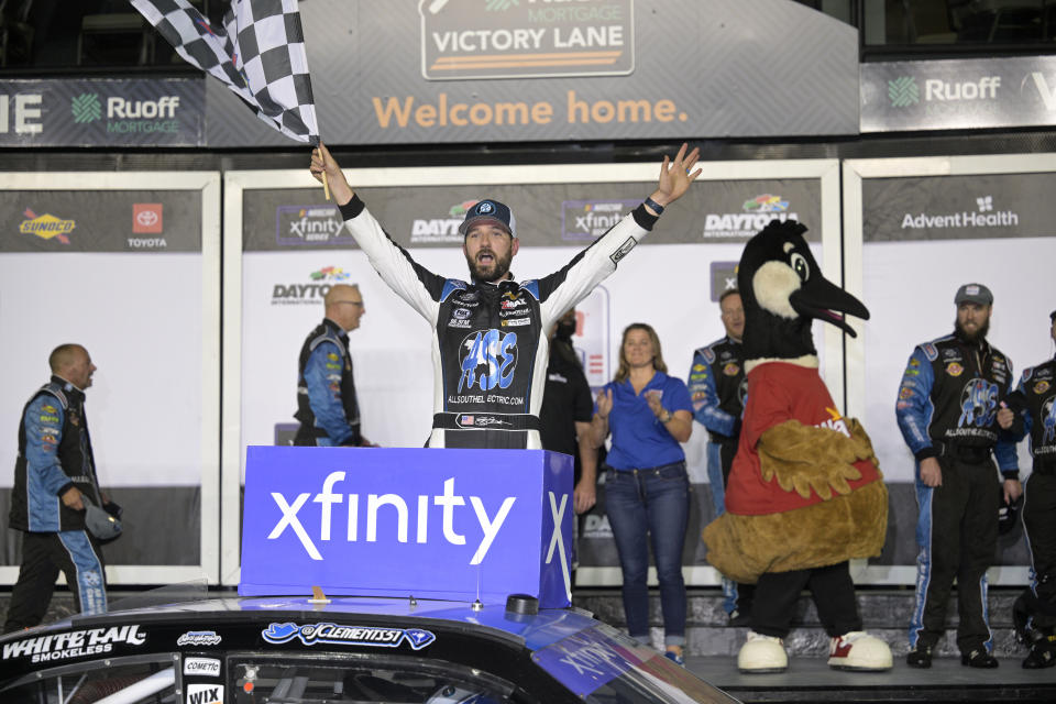 Jeremy Clements celebrates in Victory Lane after winning a NASCAR Xfinity Series auto race at Daytona International Speedway, Saturday, Aug. 27, 2022, in Daytona Beach, Fla. (AP Photo/Phelan M. Ebenhack)