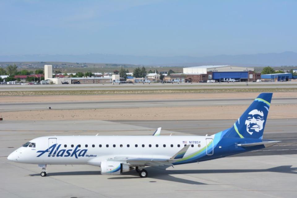 An Alaska Airlines regional jet parked on the tarmac