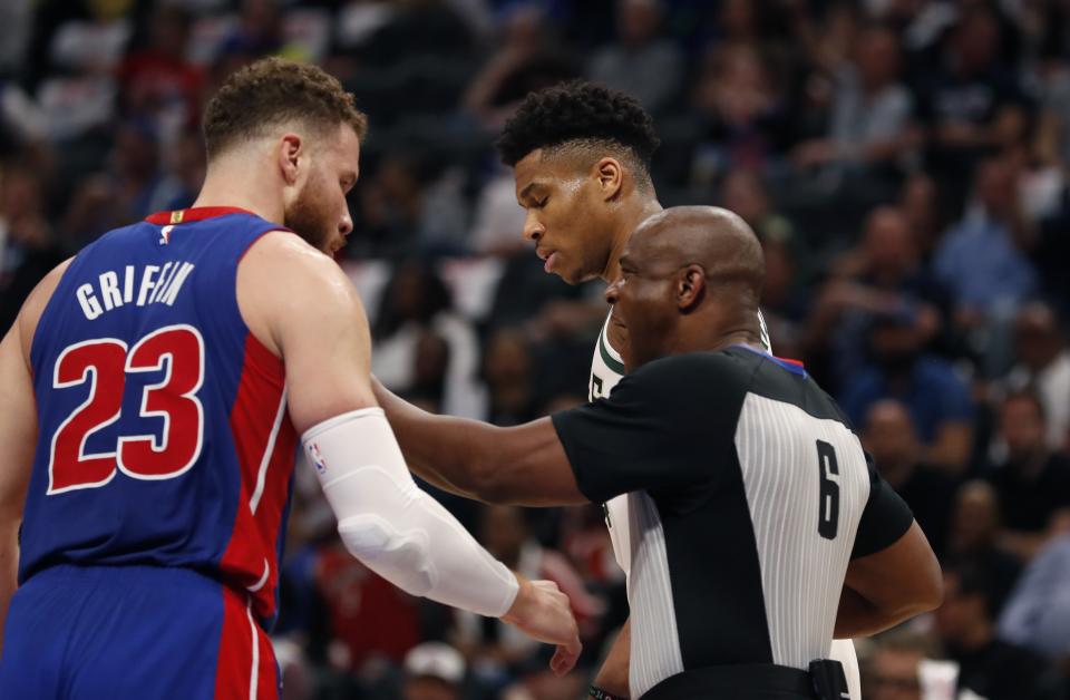 Referee Tony Brown (6) keeps Detroit Pistons forward Blake Griffin (23) and Milwaukee Bucks forward Giannis Antetokounmpo apart during the first half of Game 4 of a first-round NBA basketball playoff series, Monday, April 22, 2019, in Detroit. (AP Photo/Carlos Osorio)