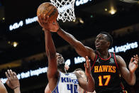 Atlanta Hawks forward Onyeka Okongwu (17) battles Sacramento Kings forward Harrison Barnes (40) for a rebound in the second half of an NBA basketball game Wednesday, Jan. 26, 2022, in Atlanta. (AP Photo/John Bazemore)