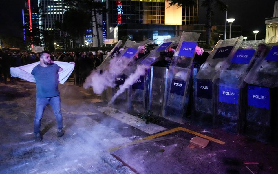 People clash with anti riot policemen outside the Israeli consulate during a protest to show solidarity with Palestinians, in Istanbul, Turkey, Tuesday, Oct. 17, 2023