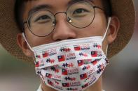 A man wears a face mask with Taiwan Flag design during a celebration in front of the Presidential Building in Taipei