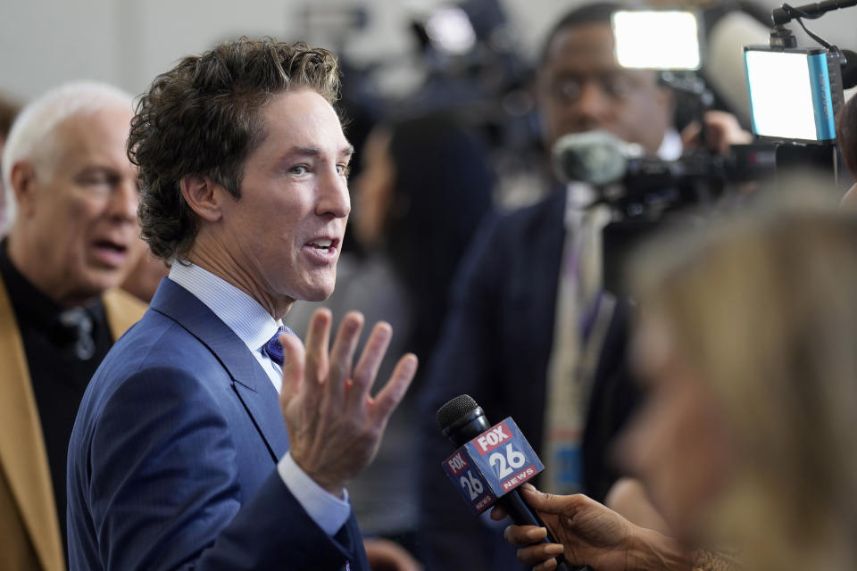 Pastor Joel Osteen talks with reporters after a service, Sunday, Feb. 18, 2024, in Houston. Pastor Osteen welcomed worshippers back to Lakewood Church for the first time since a woman with an AR-style opened fire in between services at his Texas megachurch last Sunday. (AP Photo/David J. Phillip)