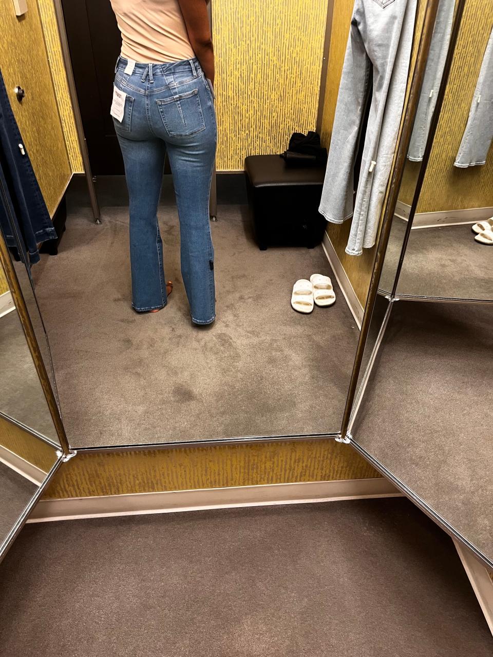 Author Joi-Marie McKenzie trying on jeans in a Nordstrom dressing room.