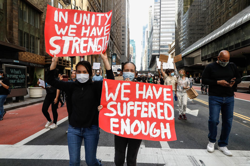 <i>New York protesters take part in a June 1 demonstration in response to the death of George Floyd. The sign on the left reads: "In unity we have strength;" the one on the right reads: "We have suffered enough." </i>