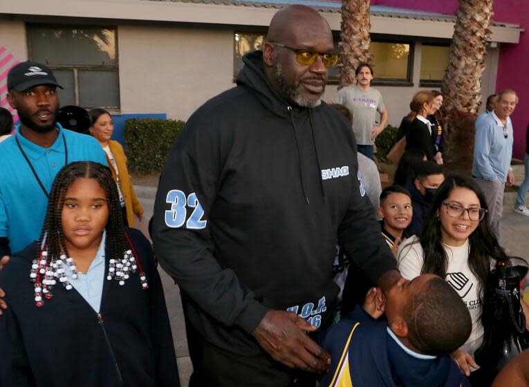 Shaquille O'Neal meets with kids during the unveiling of a new basketball court at the Challengers Boys & Girls Club