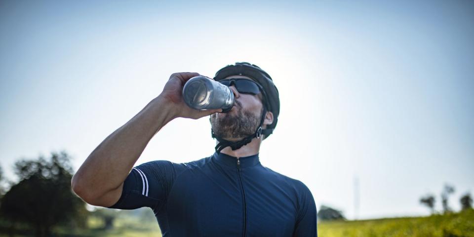 mid adult male road biker enjoying water break are their benefits to dry january