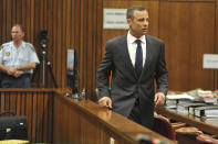 Oscar Pistorius, right, arrives at a court in Pretoria, South Africa, Monday, March 24, 2014. Pistorius is on trial for the shooting death of his girlfriend Reeva Steenkamp on Valentines Day 2013. (AP Photo/Ihsaan Haffejee, Pool)