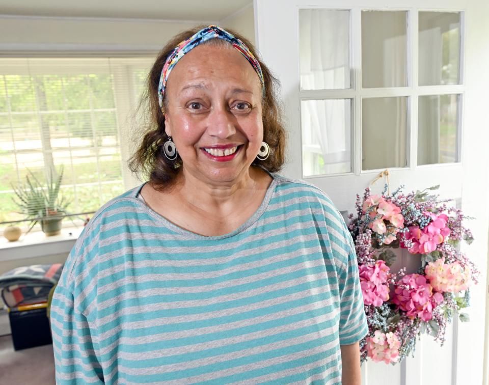 Angelina Chilaka, posing in her Harwich home on May 27,  was chosen as this year's  Mercy Otis Warren Cape Cod Woman of the Year. She is a retired Harwich High School teacher and an active advocate for public health and social justice. Ron Schloerb/Cape Cod Times