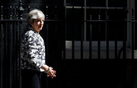 Britain's Prime Minister, Theresa May, waits to greet Democratic Unionist Party (DUP) Leader Arlene Foster, in Downing Street, in central London, Britain June 26, 2017. REUTERS/Stefan Wermuth