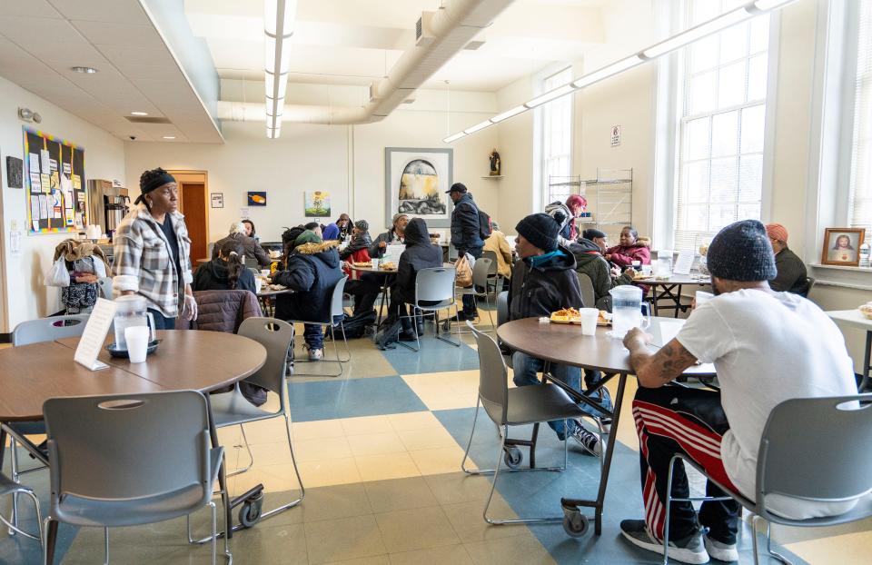 People attend the Open Door Café for the free hot lunch program at the Cathedral of St. John the Evangelist on Thursday April 4, 2024 in Milwaukee, Wis.