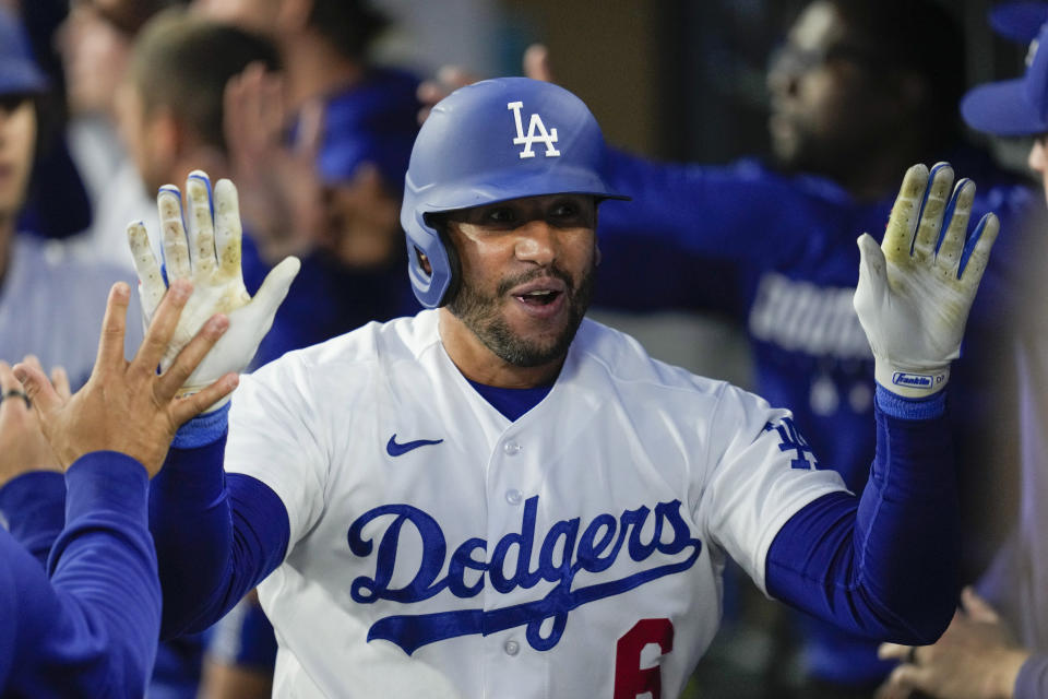 FILE - Los Angeles Dodgers' David Peralta (6), of Venezuela, celebrates with teammates after hitting a home run during the second inning of a baseball game against the Philadelphia Phillies in Los Angeles, Monday, May 1, 2023. Long before David Peralta was a veteran outfielder for the Los Angeles Dodgers, he was an 18-year-old kid from Venezuela who didn't speak much English playing minor league baseball in the town of Johnson City, Tennessee. (AP Photo/Ashley Landis, File)