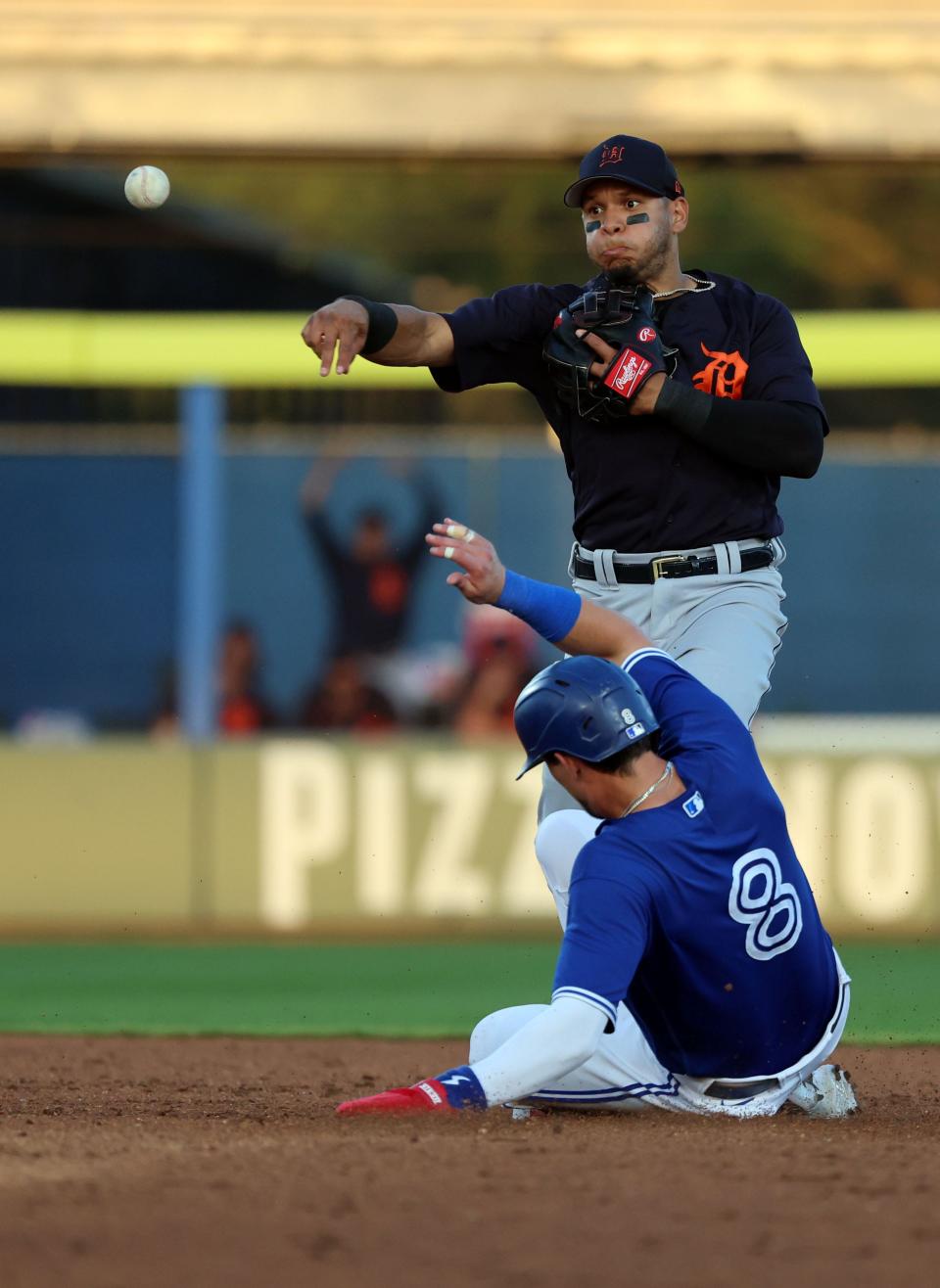 Detroit Tigers infielder Cesar Hernandez (15) forces out Toronto Blue Jays infielder Cavan Biggio (8) and throws the ball to first base for a double play during the fifth inning at TD Ballpark in Dunedin, Florida, on Saturday, March 25, 2023.