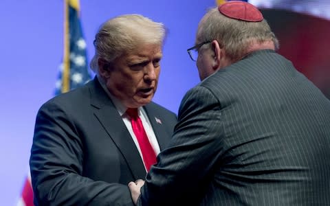 President Donald Trump embraces Rabbi Benjamin Sendrow at the 91st annual Future Farmers of America Convention in Indianapolis - Credit: AP