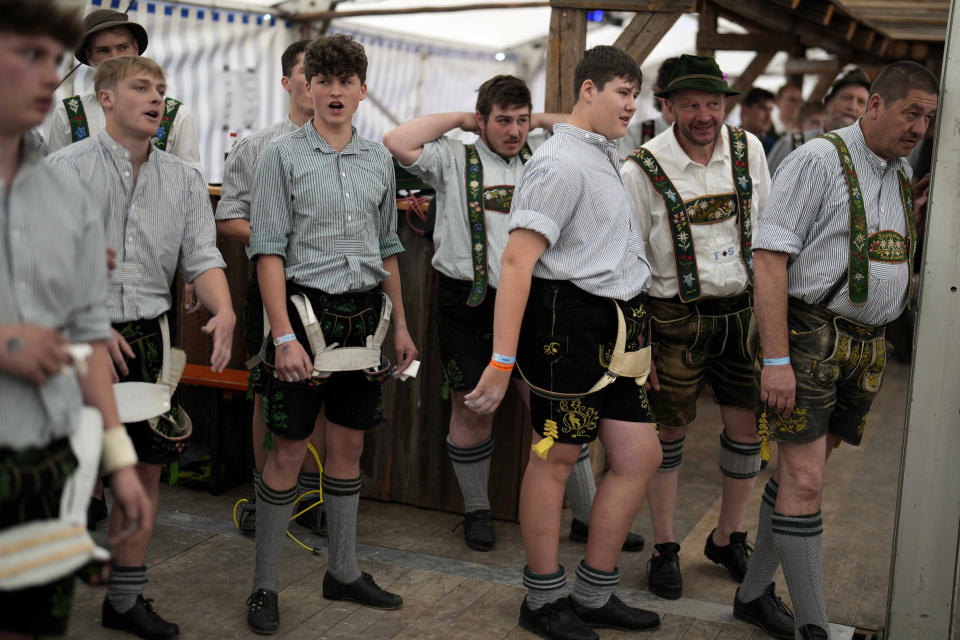 Competitors in traditional clothes warm up for their bouts at the German Championships in Fingerhakeln or finger wrestling, in Bernbeuren, Germany, Sunday, May 12, 2024. Competitors battled for the title in this traditional rural sport where the winner has to pull his opponent over a marked line on the table. (AP Photo/Matthias Schrader)