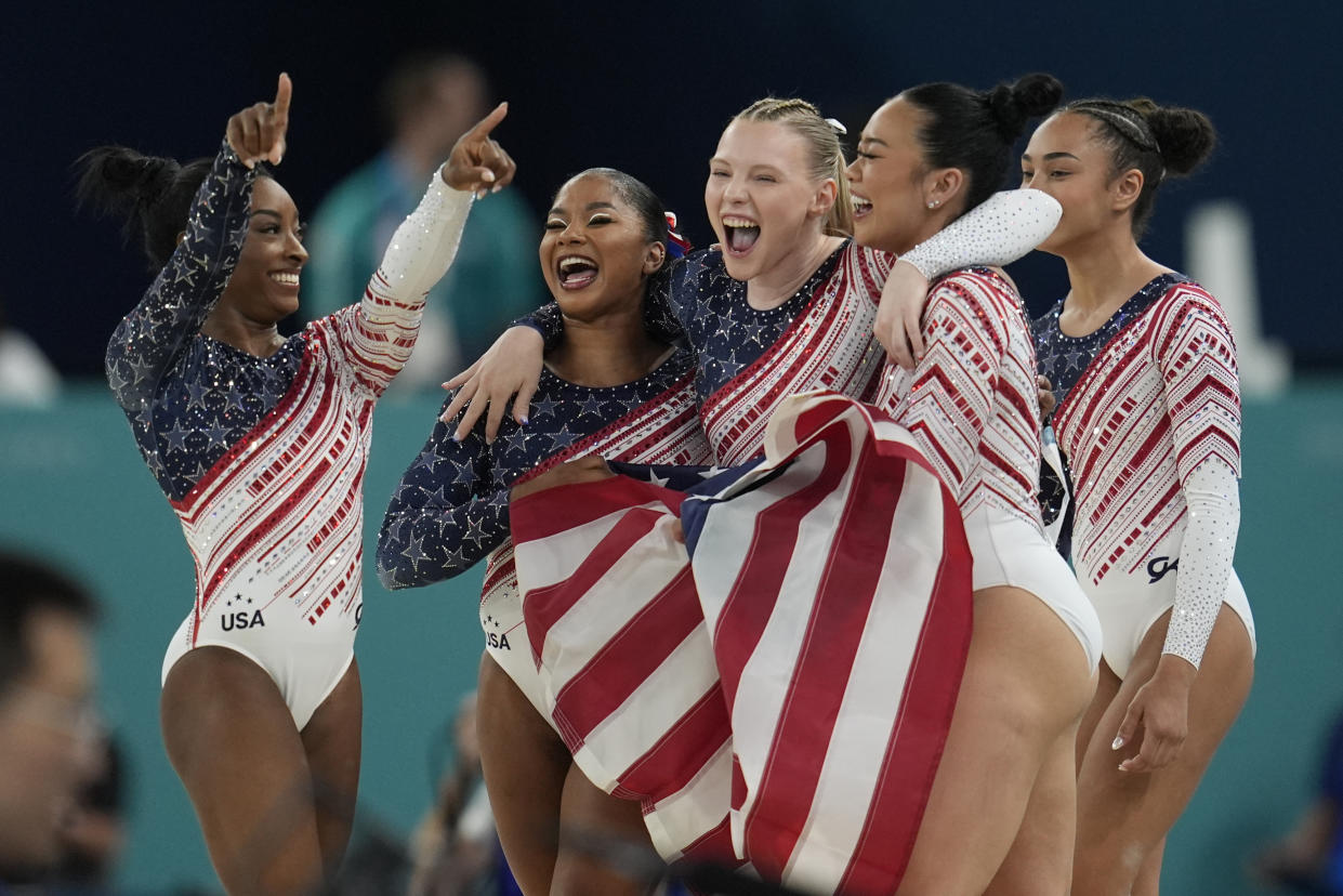 Members of Team USA celebrate after winning the gold medal during the women's artistic gymnastics team finals round at Bercy Arena at the 2024 Summer Olympics on July 30, 2024, in Paris, France. (Abbie Parr/AP)