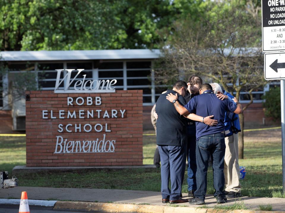 People gather at Robb Elementary School, the scene of a mass shooting in Uvalde, Texas, U.S. May 25, 2022.