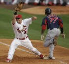 FILE - In this March 8, 2012, file photo, Boston Red Sox's Pedro Ciriaco (77) beats the throw to St. Louis Cardinals first baseman Mark Hamilton in the eighth inning of a spring training baseball game in Jupiter, Fla. Hamilton, the fill-in first baseman for the 2011 St. Louis Cardinals, is set to graduate a month early from medical school on Long Island on Friday, April 10, 2020. Next stop for the rookie doc, most likely, the first-hand fight against the coronavirus pandemic. (AP Photo/Patrick Semansky, File)