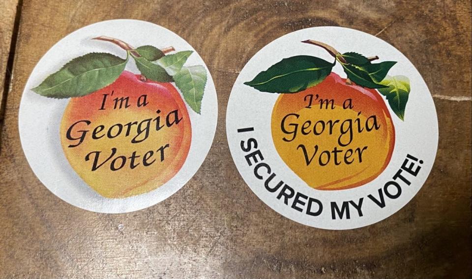 Georgia voters received a sticker (right) for voting in the 2022 primaries to signify the changes made in the system since 2020. The slogan 'I secured my vote!' was not on the 2020 stickers (left).