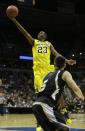 Michigan guard Caris LeVert (23) drives to the basket during the first half of a second round NCAA college basketball tournament game against the Wofford Thursday, March 20, 2014, in Milwaukee. (AP Photo/Morry Gash)