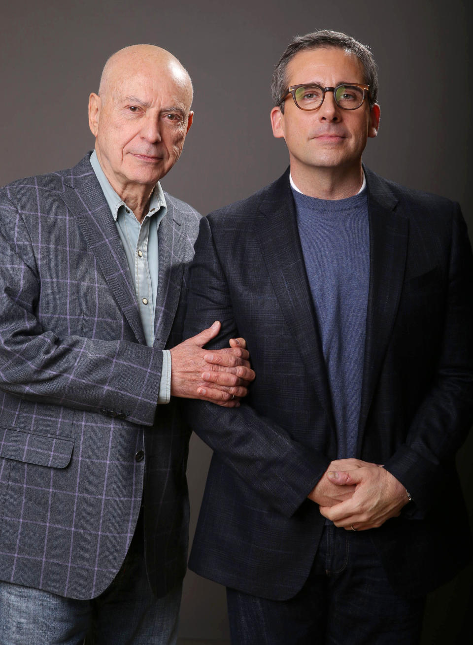 In this Monday, March 11, 2013 photo, Alan Arkin, left, and Steve Carell pose for a portrait for the film, "The Incredible Burt Wonderstone," at the Hotel Amarano, in Los Angeles. The 78-year-old Oscar winner plays the master magician who helps Carell's character find his life's calling in “The Incredible Burt Wonderstone.” And Carell, a producer of the film, had everything to do with that. (Photo by Eric Charbonneau/Invision/AP)