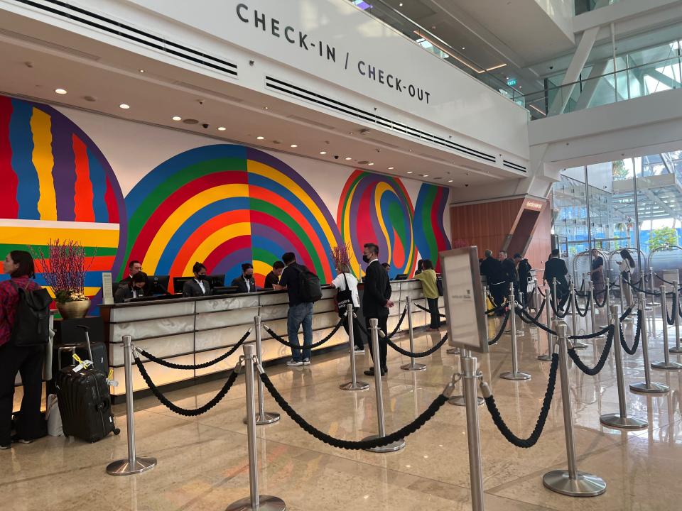 The check-in desk with colorful backdrop.