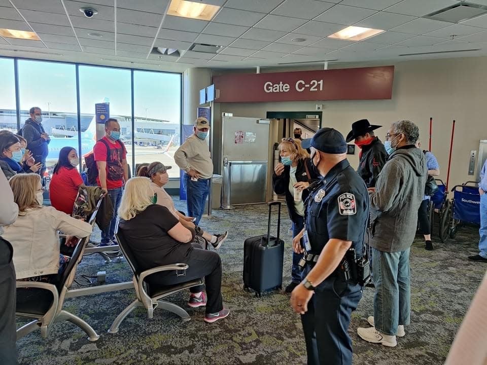 Passengers congregate at Nashville International Airport on Nov. 3, 2020, after a woman who refused to wear a face mask forced a Southwest aircraft to return to the gate and all its passengers to deplane.